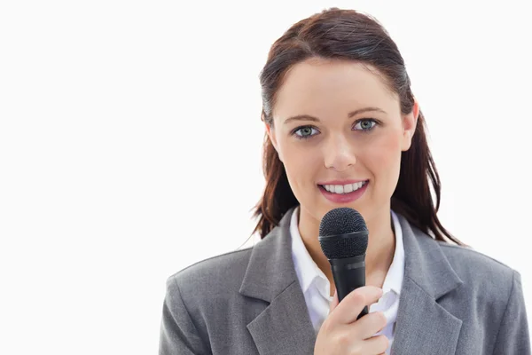 Businesswoman holding a microphone — Stock Photo, Image