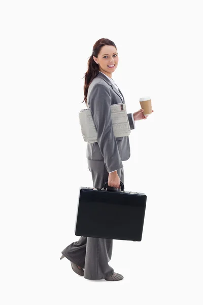 Stock image Profile of a businesswoman smiling and walking with a briefcase,