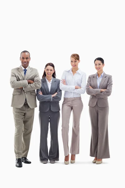 Business team smiling side by side and crossing their arms — Stock Photo, Image