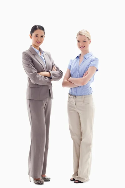 Two smiling women crossing their arms — Stock Photo, Image