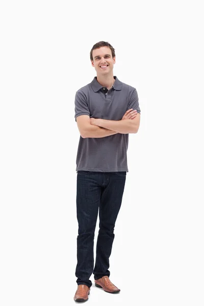 Standing man smiling while crossing his arms — Stock Photo, Image