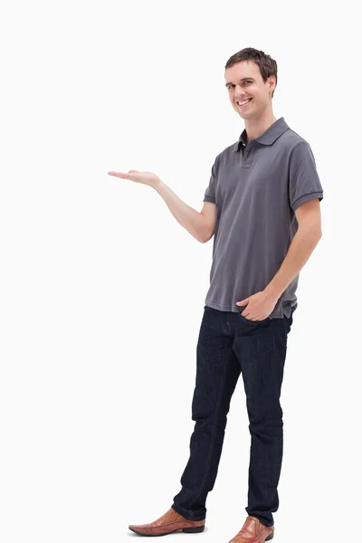 Standing man smiling and presenting — Stock Photo, Image