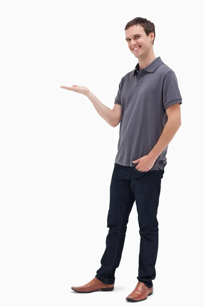 Happy man standing while presenting — Stock Photo, Image