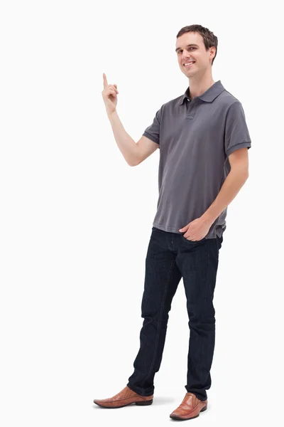 Happy man standing and presenting something above — Stock Photo, Image
