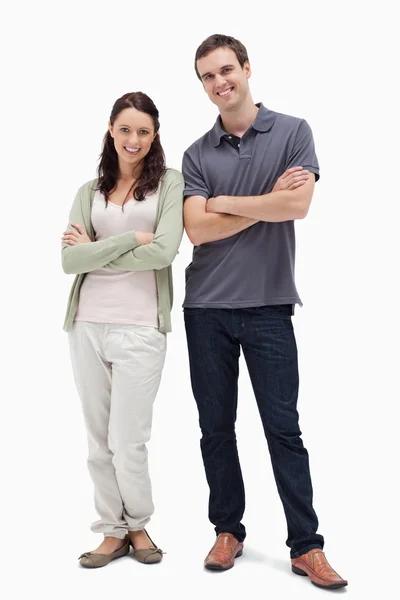 Smiling couple crossing their arms — Stock Photo, Image