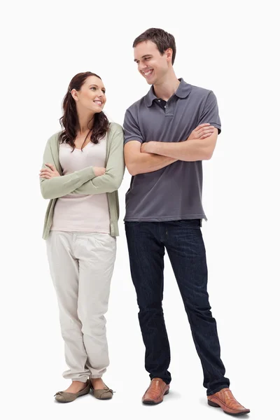 Couple with a complicit smile while crossing their arms — Stock Photo, Image
