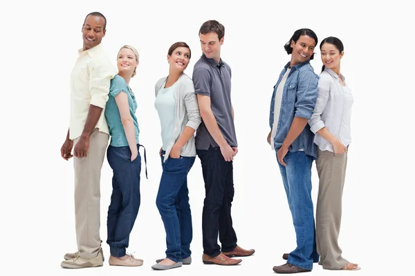 Three couples standing back to back looking at each other — Stock Photo, Image