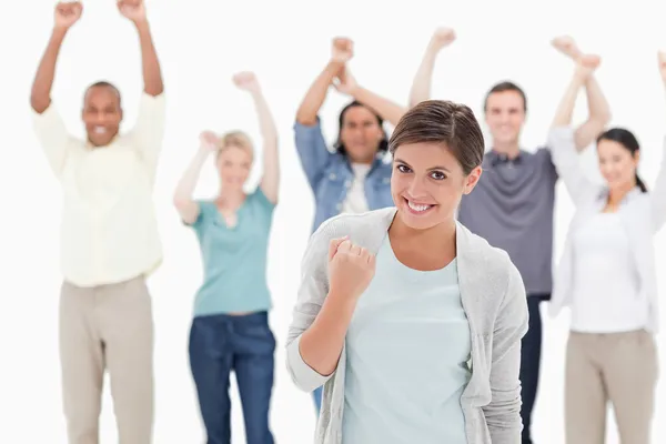 Woman clenching her fist with behind raising their arms — Stock Photo, Image