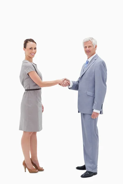 White hair man face to face and shaking hands with a woman — Stock Photo, Image