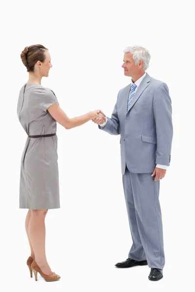 White hair businessman face to face and shaking hands with a wom — Stock Photo, Image
