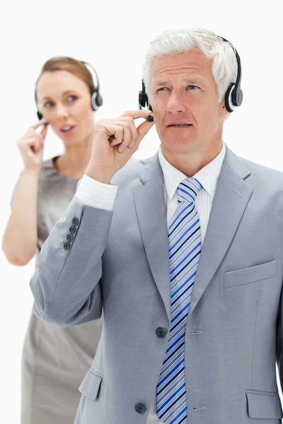 Close-up of a white hair businessman with a woman talking in bac — Stock Photo, Image