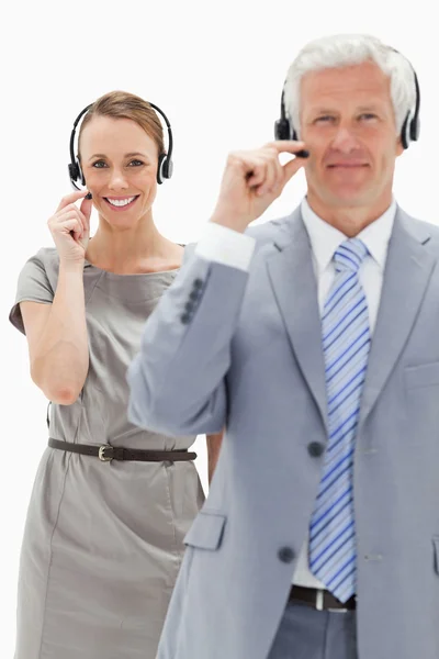 Close-up of a smiling woman in background and wearing a headset — Stock Photo, Image