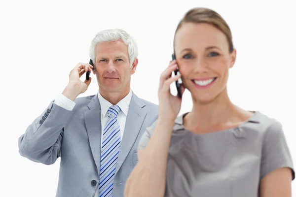 Close-up of a white hair businessman making a call with a smilin — Stock Photo, Image