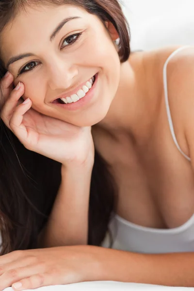 Close up Woman with a hand on her cheek, smiling and looking str — Stock Photo, Image