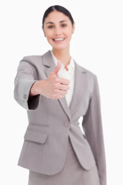Thumb up given by smiling businesswoman — Stock Photo, Image