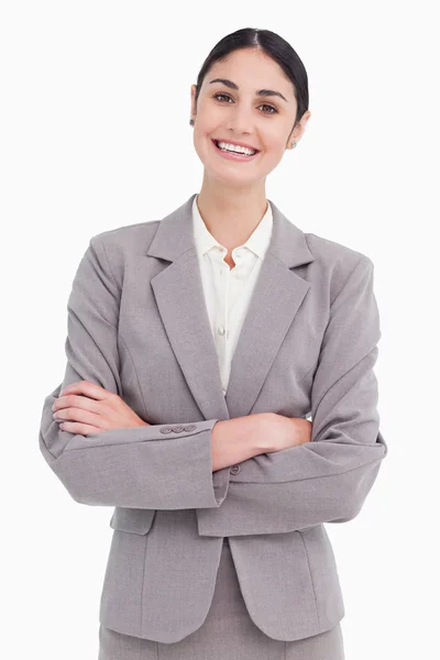 Smiling young saleswoman with arms crossed — Stock Photo, Image