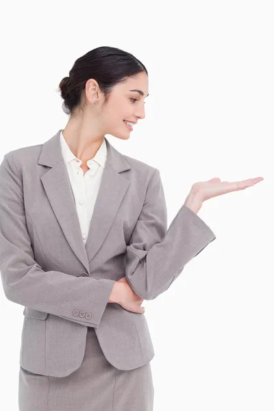 Young businesswoman looking at her palm — Stock Photo, Image