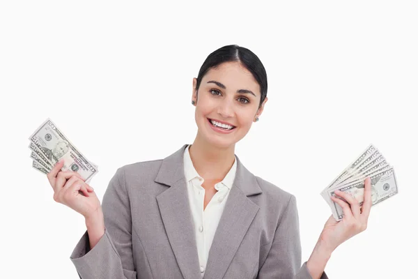 Smiling saleswoman with money in her hands — Stock Photo, Image