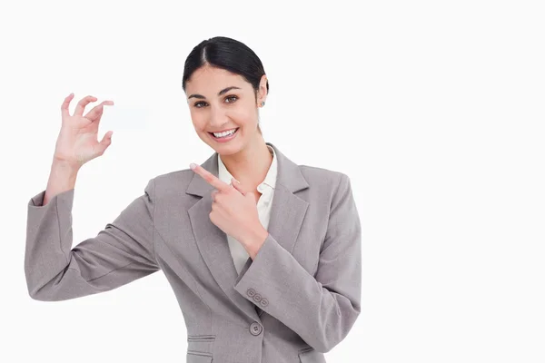 Smiling saleswoman pointing at her business card — Stock Photo, Image