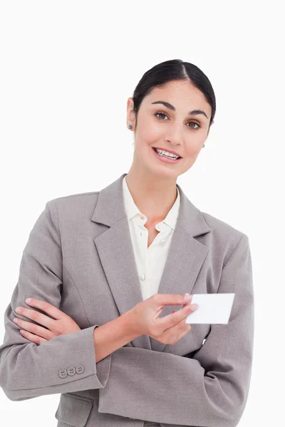 Saleswoman with arms folded and business card — Stock Photo, Image