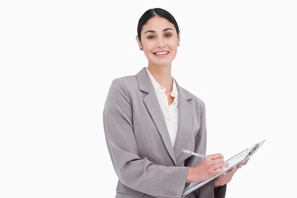 Smiling businesswoman with pen and clipboard — Stock Photo, Image