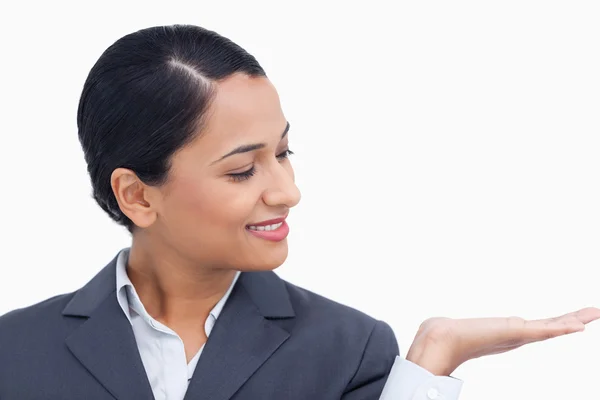 Close up of saleswoman looking at her palm — Stock Photo, Image