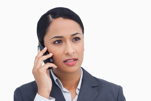 Close up of saleswoman listening to caller — Stock Photo, Image