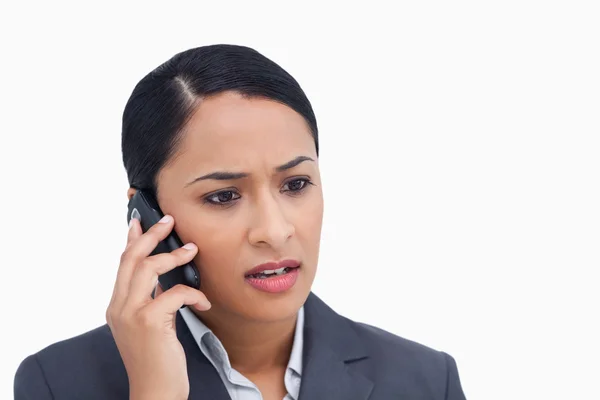 Close up of negative surprised saleswoman on her cellphone — Stock Photo, Image