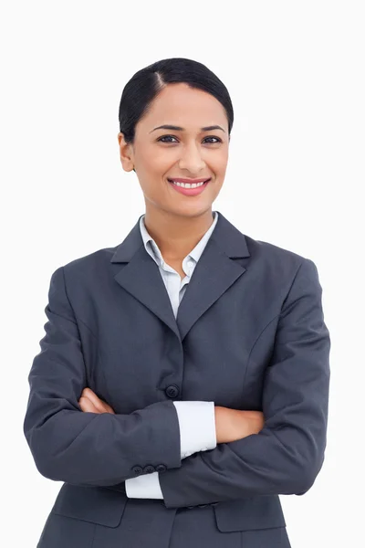Close up of smiling saleswoman with arms folded — Stock Photo, Image