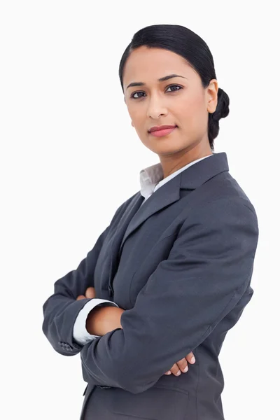 Close up of serious saleswoman with arms folded — Stock Photo, Image