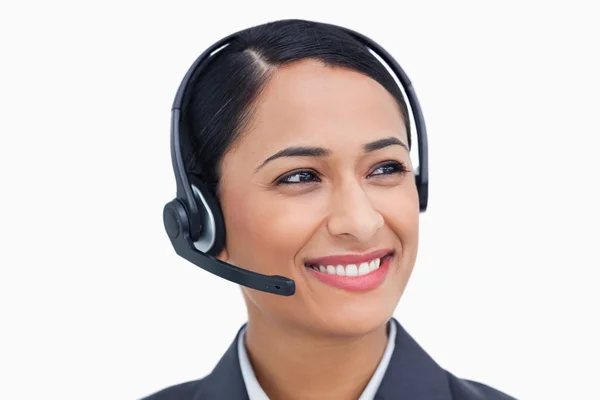 Close up of smiling call center agent looking to the side — Stock Photo, Image