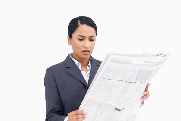 Close up of saleswoman reading news paper — Stock Photo, Image