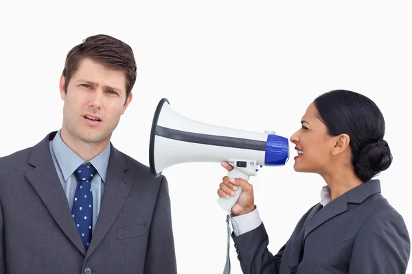 Close up of saleswoman with megaphone yelling at colleague — Stock Photo, Image