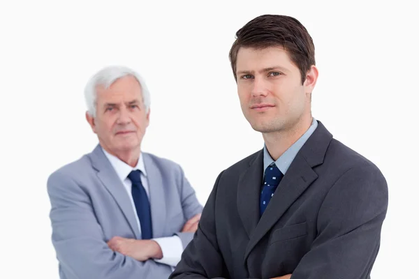 Close up of young businessman with his mentor behind him — Stock Photo, Image