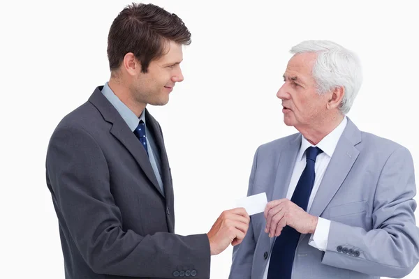 Close up of businessman giving business card to trades partner — Stock Photo, Image