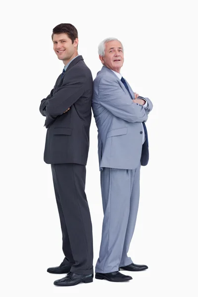 Businessmen standing back to back — Stock Photo, Image
