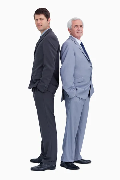 Businessman standing back to back with his mentor — Stock Photo, Image