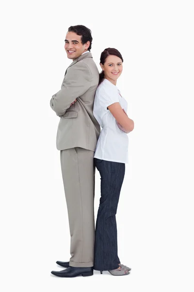 Smiling salesteam standing back to back — Stock Photo, Image