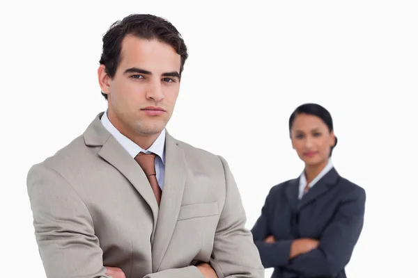 Serious salesman with colleague behind him — Stock Photo, Image