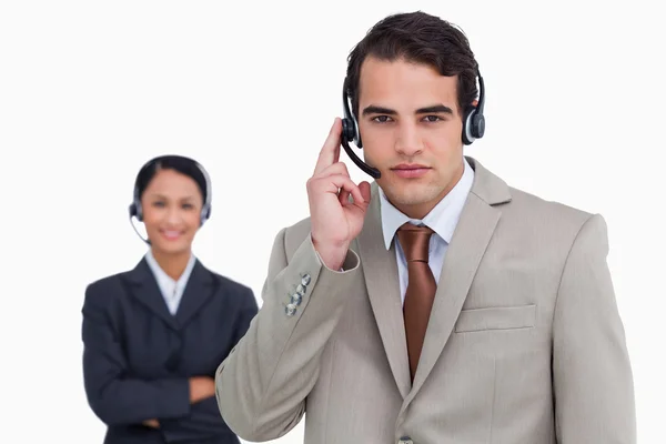 Hotline employee with colleague behind him — Stock Photo, Image