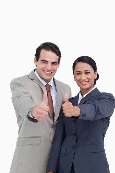 Smiling young salesteam giving thumbs up — Stock Photo, Image