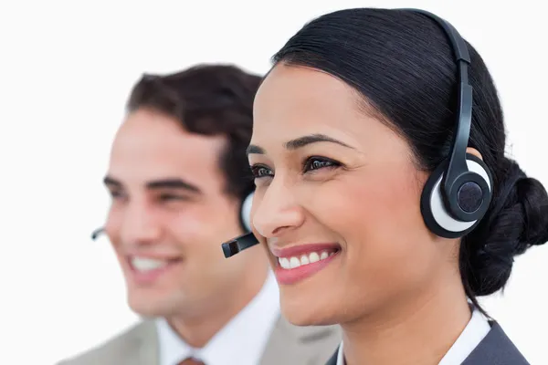 Close up side view of smiling call center agents — Stock Photo, Image