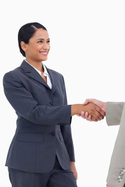 Smiling saleswoman shaking hand — Stock Photo, Image