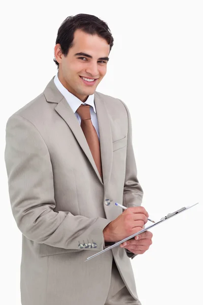 Smiling salesman with notepad and pen — Stock Photo, Image