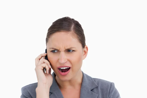 Close up of angry tradeswoman yelling at caller — Stock Photo, Image