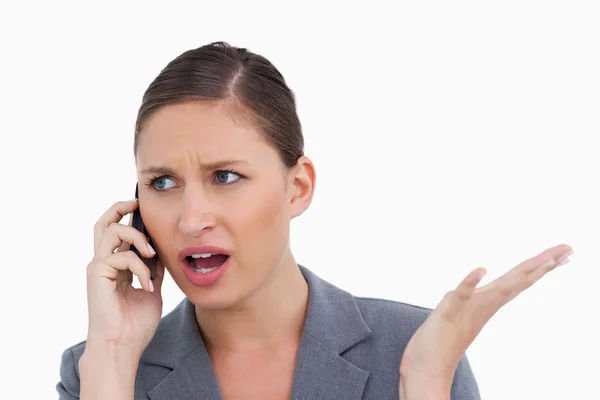 Close up of irritated tradeswoman on her cellphone — Stock Photo, Image