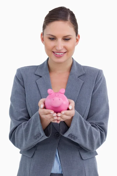 Smiling bank clerk with piggy bank — Stock Photo, Image