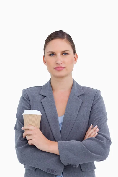 Tradeswoman with arms folded and paper cup — Stock Photo, Image