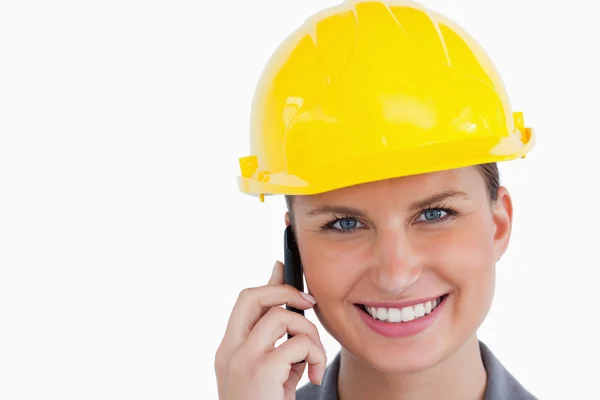 Крупный план улыбающейся женщины-архитектора на мобильном телефоне — стоковое фото