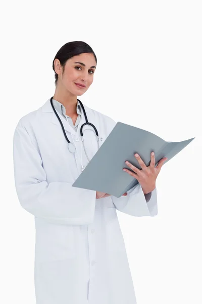 Smiling female doctor with patients record — Stock Photo, Image